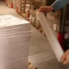 A person using Custom Printed Stretch Film for boxes packaging.