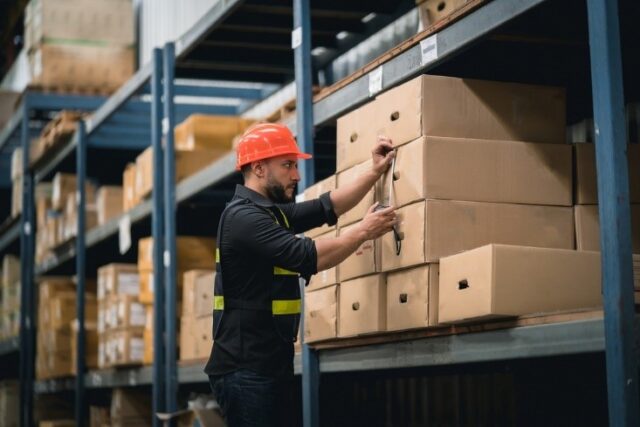 man measuring the box dimensions